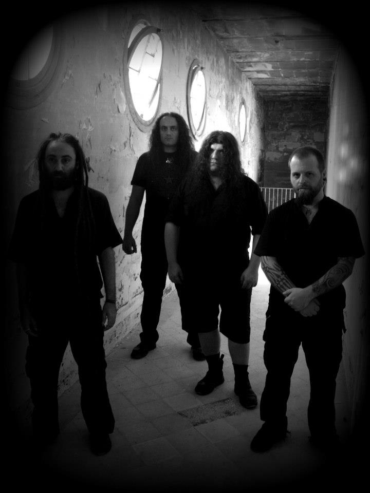 Victims of Creation, four members photographed in a corridor